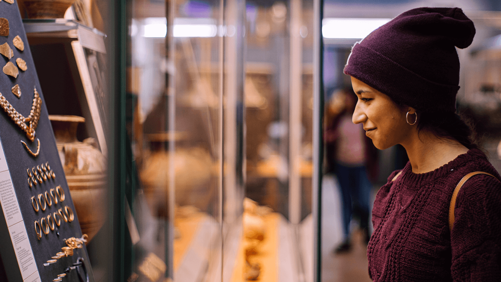 Woman looking at ancient jewlery in the British Museum