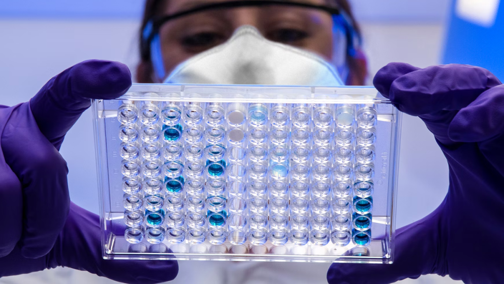 Lab worker holding lab equipment