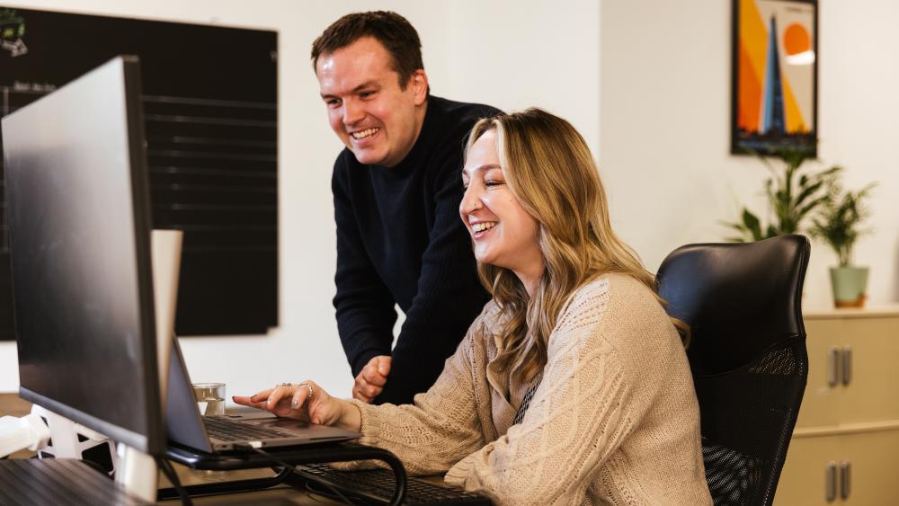 two people looking at a monitor 