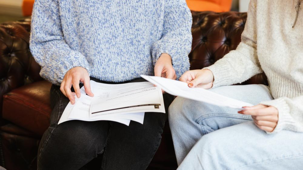 two people holding papers
