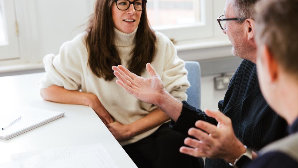 three people discussing something animatedly