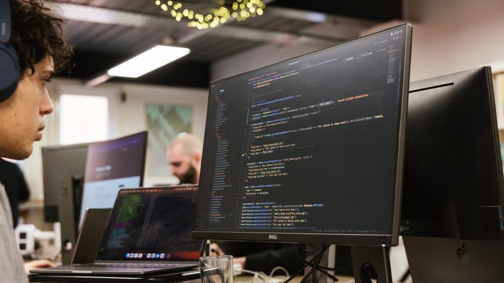 developer looking at code on a monitor