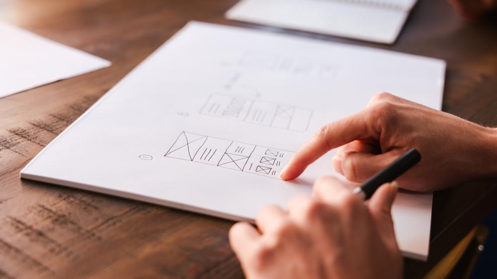 a hand pointing at a diagram