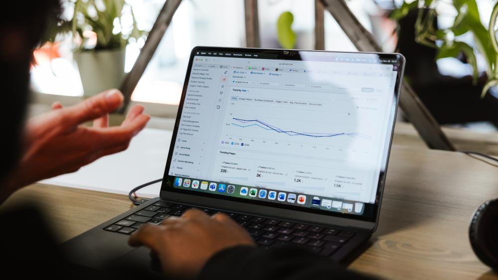 Laptop screen showing google analytics, with hands in foreground