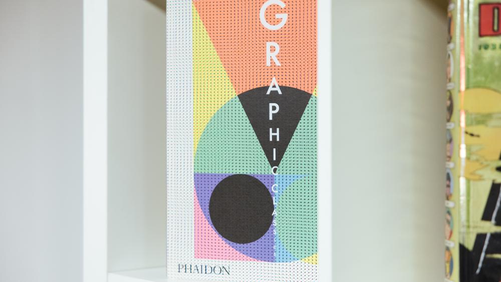 A book on graphic design on a shelf