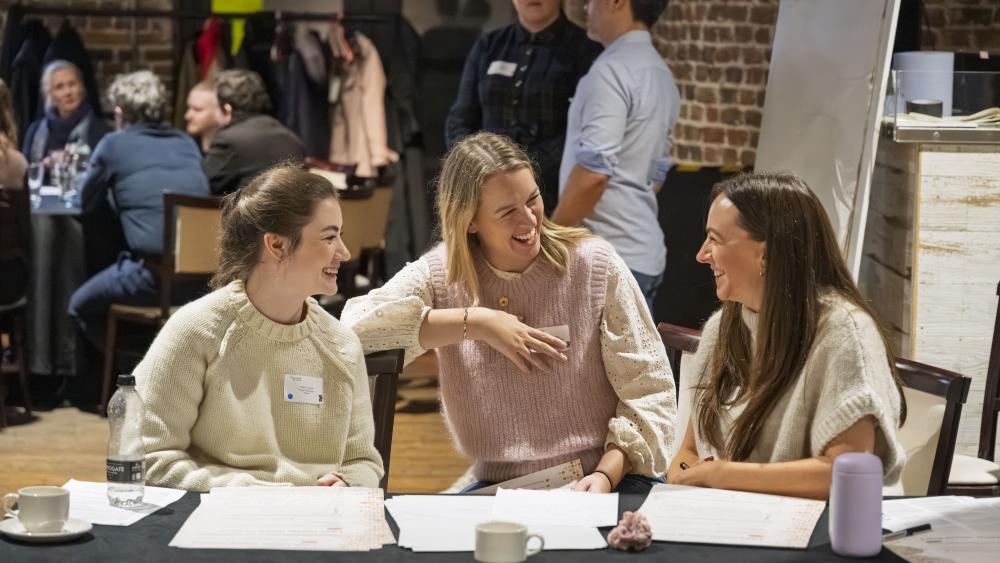 Chloe, Marie and Tace chatting at a table 