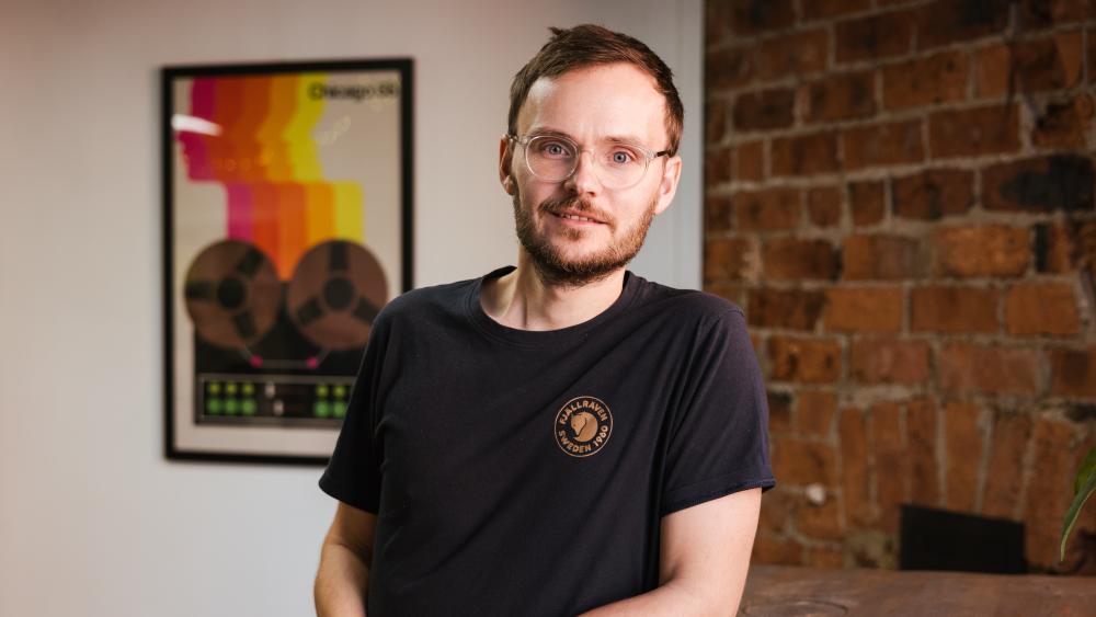 Daniel posing for a headshot in the Numiko office