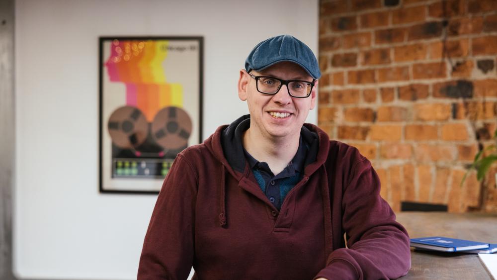 Andy posing for a headshot in the Numiko office