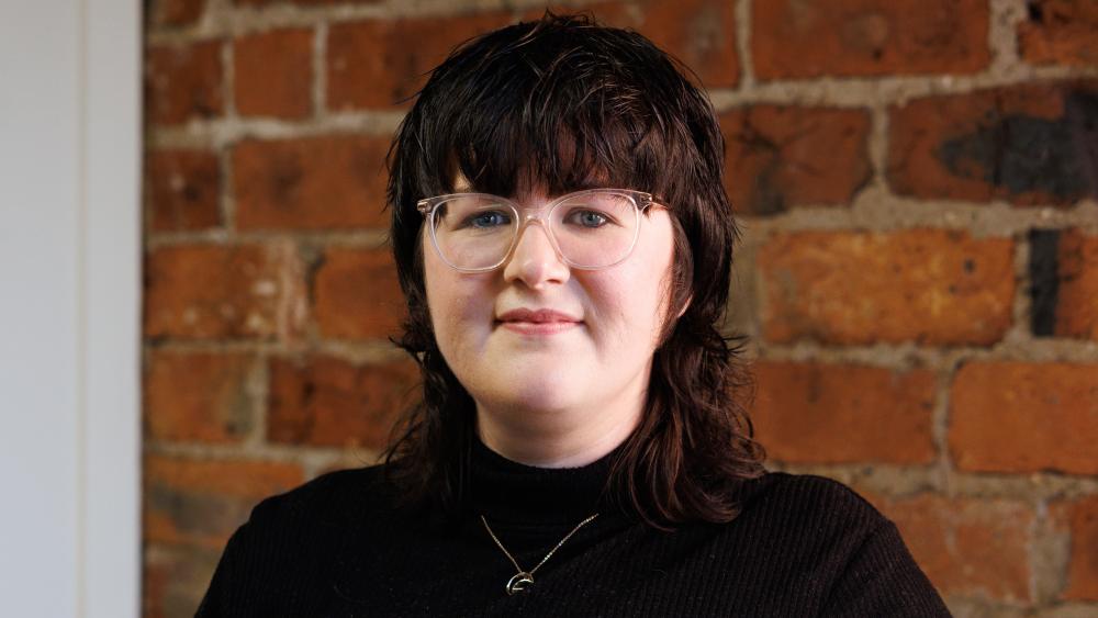 Kelly posing for a headshot in the Numiko office