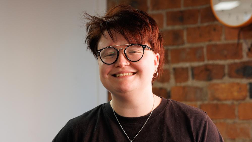 Soph posing for a headshot in the Numiko office