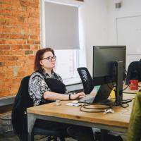 Soph working on a monitor at a desk in the Numiko office