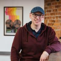 Andy posing for a headshot in the Numiko office