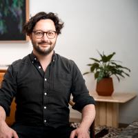 Tom sat down posing for a headshot 
