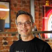 Jaron posing for headshot in Numiko office