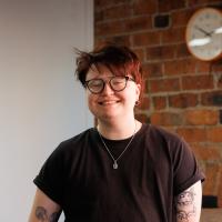 Soph posing for a headshot in the Numiko office